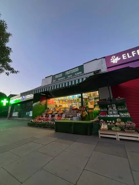 Parade Fruiterers lit up on St John's Parade, West Ealing, display set out and ready for customers